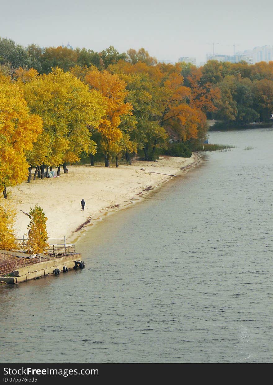 Lone man walking along promenade of autumn. Lone man walking along promenade of autumn.