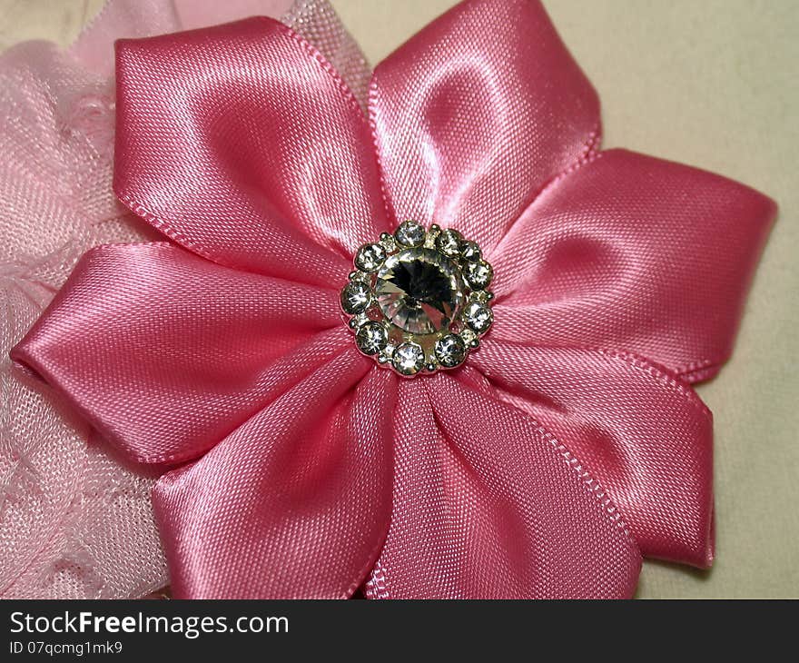 Satin pink flower with brooch with faux rhinestone