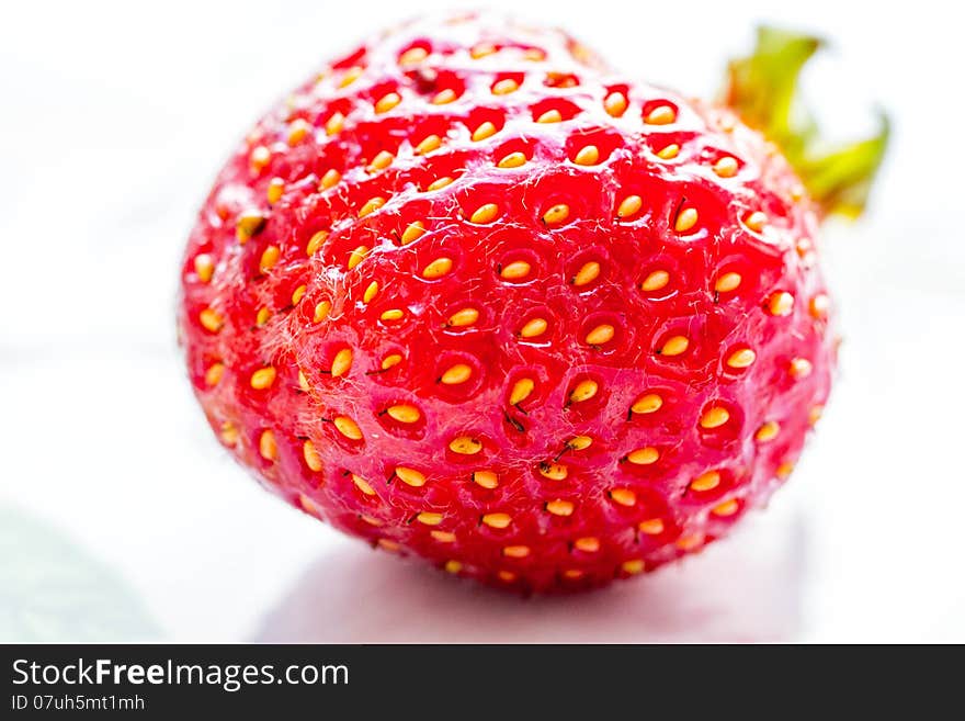 Strawberry close-up lying on white table. Strawberry close-up lying on white table