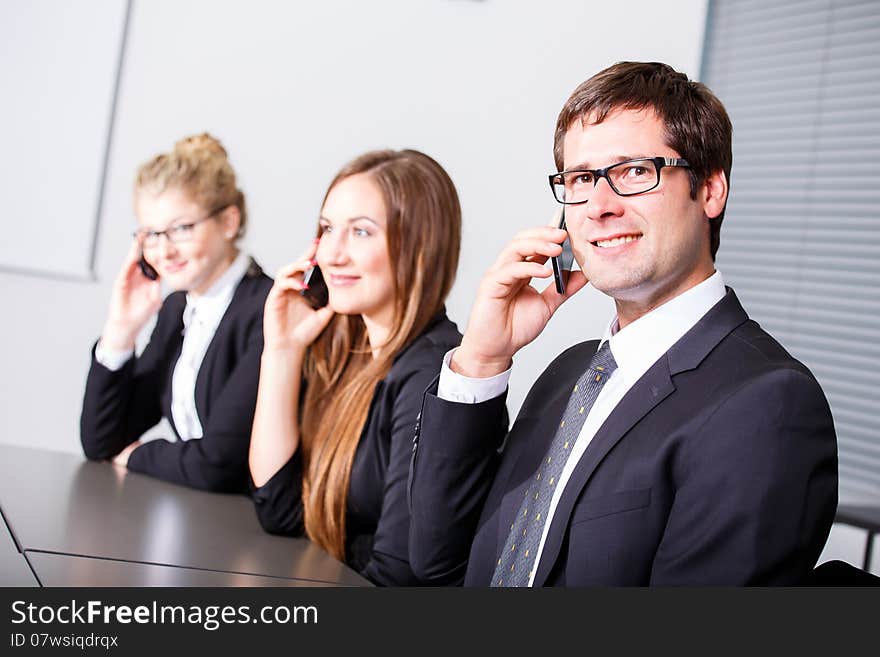 Happy smiling women in business meeting having phone call. Happy smiling women in business meeting having phone call