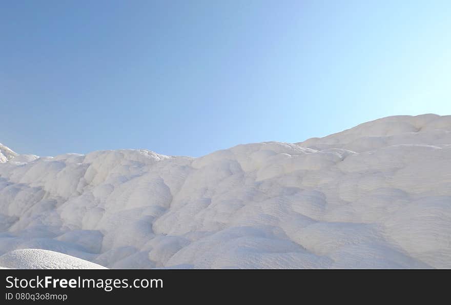 The famous travertine and a thermal pool in Pamukkale, Turkey. The famous travertine and a thermal pool in Pamukkale, Turkey