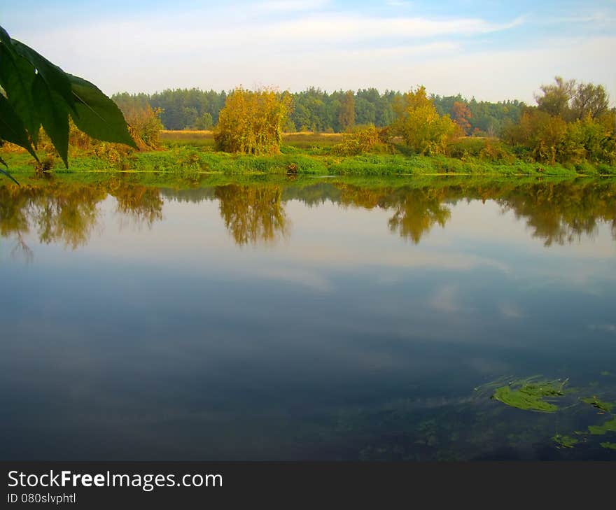 Calm river in autumn forest in the morning time. Calm river in autumn forest in the morning time.