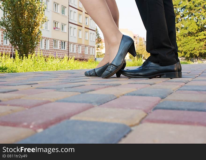 Feet of men and women on a walk in the park closeup