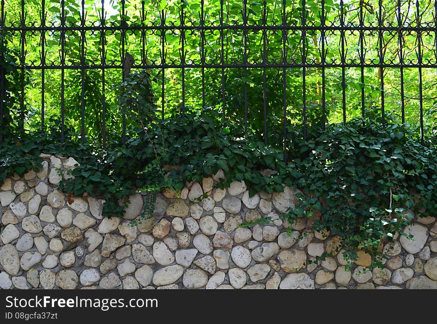 Fence with stones and metal. Fence with stones and metal