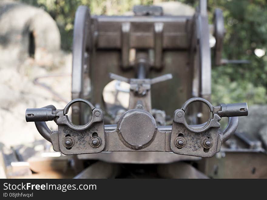 An old WWII turret or anti aircraft rests at the top of a mountain in Luang Prabang - looking down the barrel