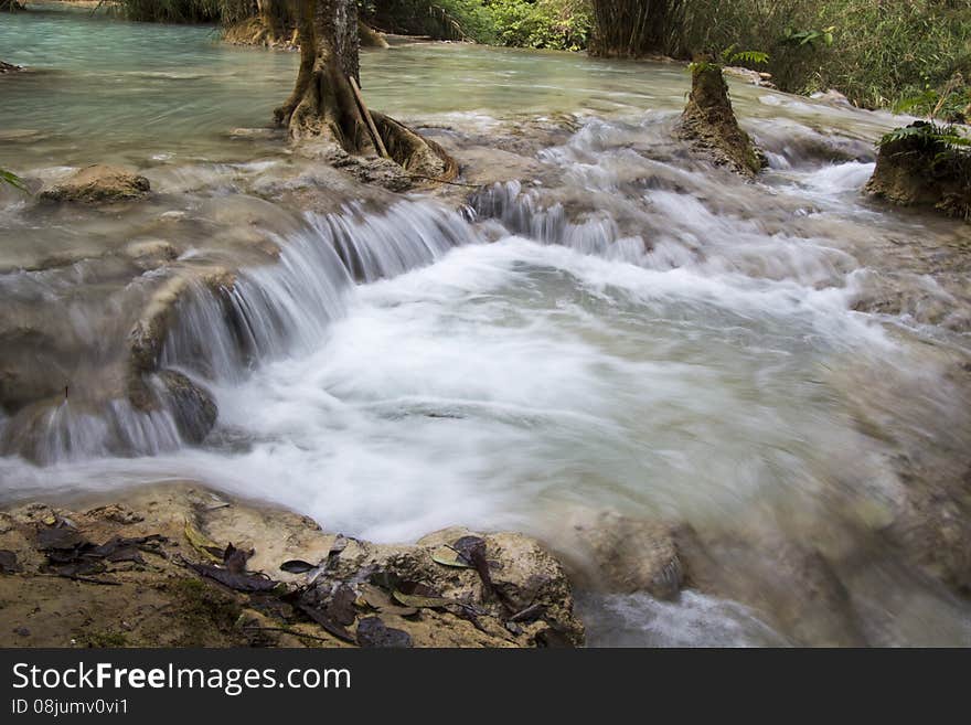 A long exposure of a clean blue waterfall creating natural pools. A long exposure of a clean blue waterfall creating natural pools