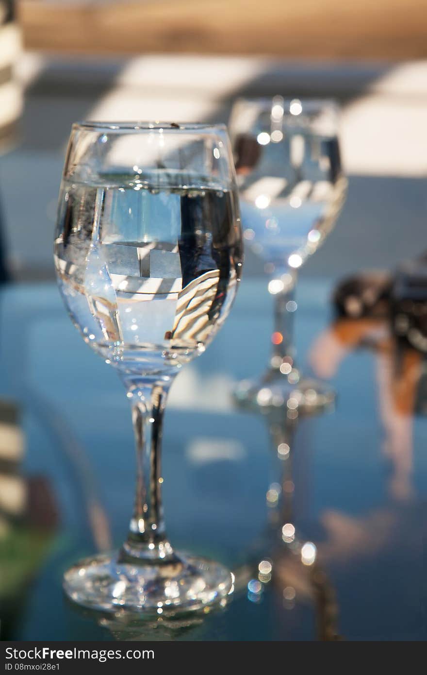 Two glasses of water and many reflections