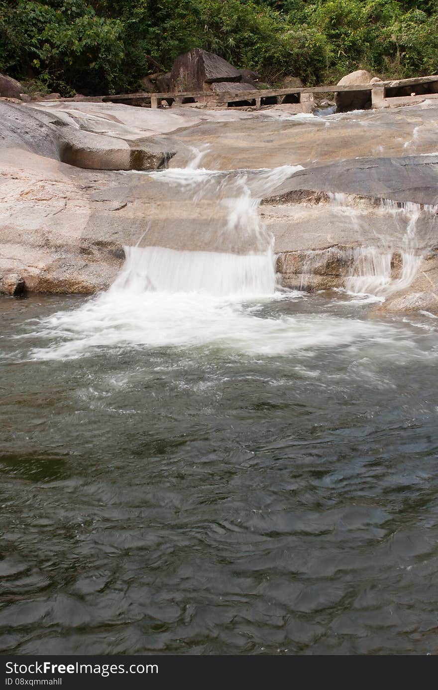 Water power from a small waterfall crossing a trail, kiriwongvillage, nakhonsithammarat, Thailand.