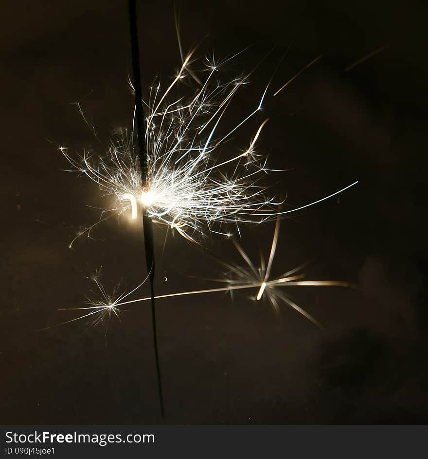 Bright christmas sparkler, bengal fire burning in the night.