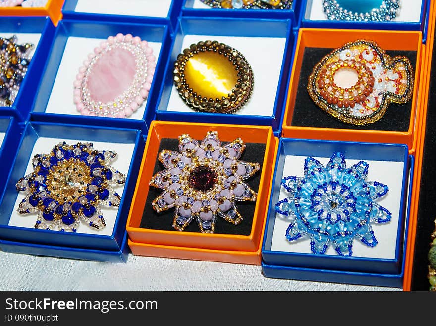 Some brooches made of glass and amber at the exhibition