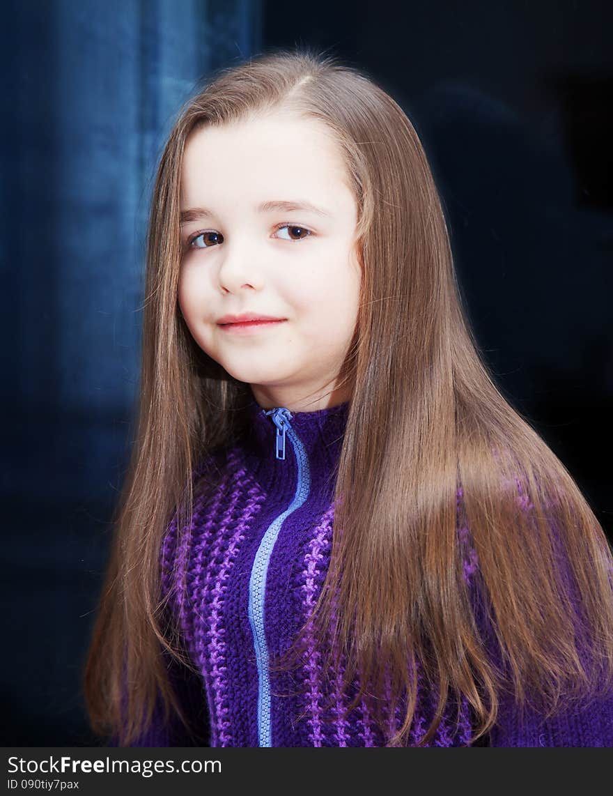 Portrait of a pretty little girl near the window