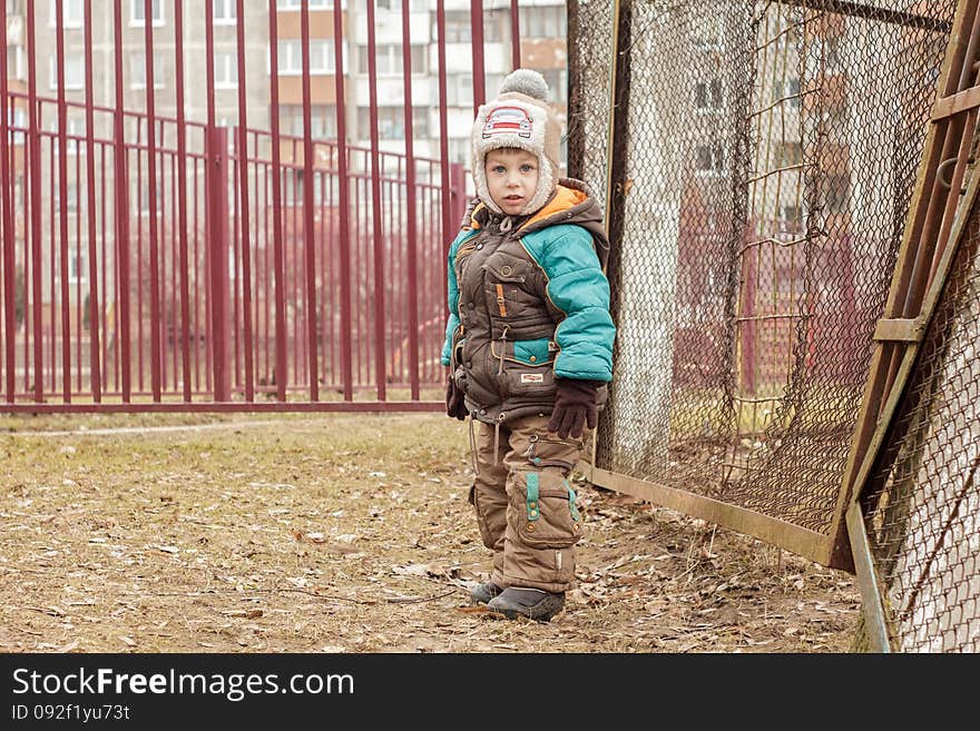 Child Standing Near The Fence