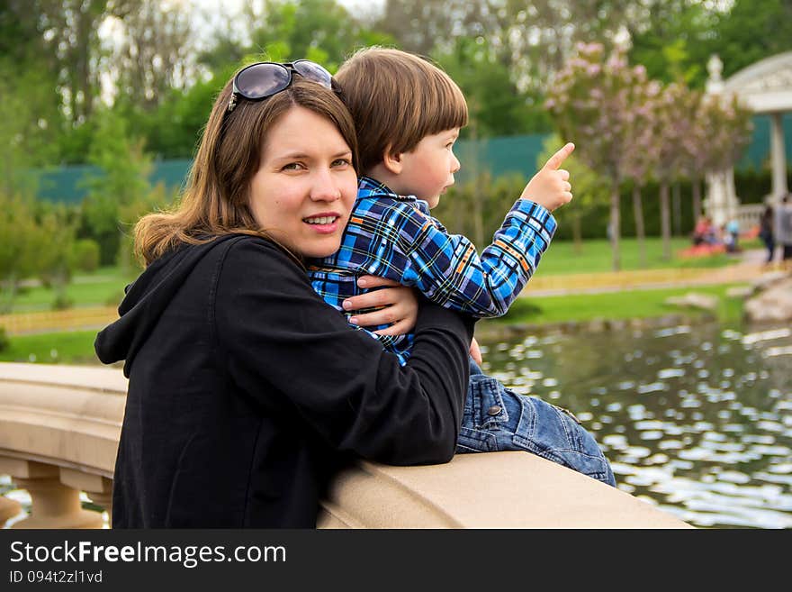 Mother and her son having wonderful time in the park in a lovely summer day. Mother and her son having wonderful time in the park in a lovely summer day