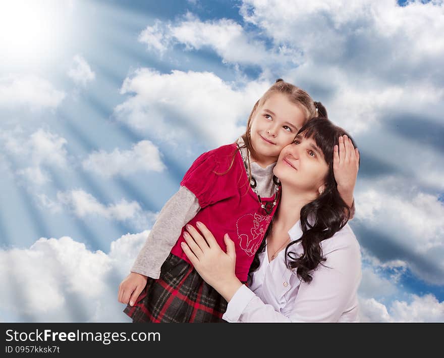 Young mother and her little daughter look up