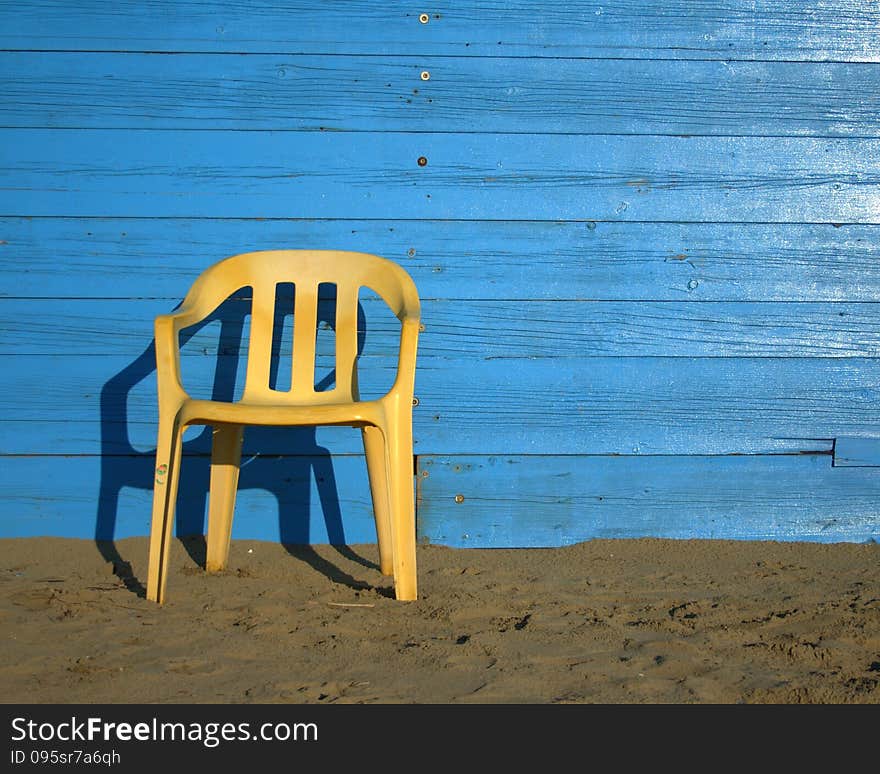 Yellow chair with blue background