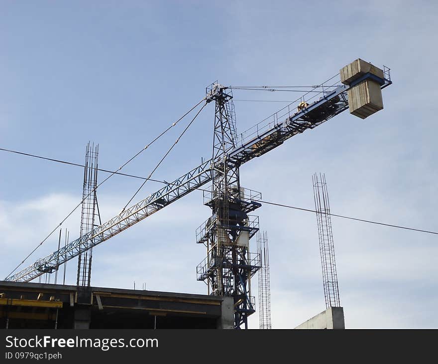 Construction crane working at a height of several tens of meters above the ground. Construction crane working at a height of several tens of meters above the ground.