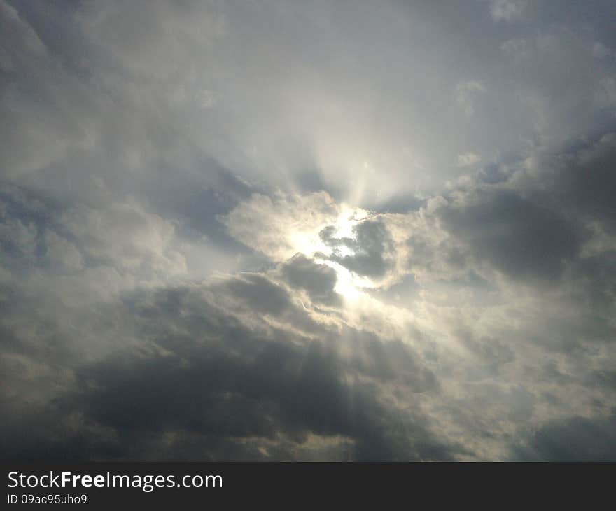 Sun behind Clouds in the Sky in Jersey City, NJ. Sun behind Clouds in the Sky in Jersey City, NJ.