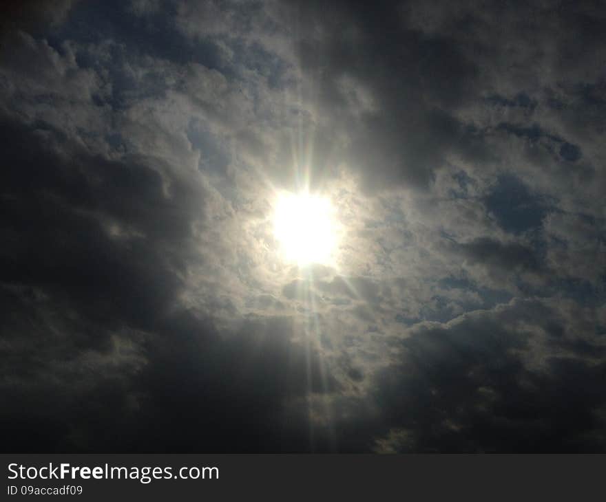 Sun behind Clouds in the Sky in Jersey City, NJ. Sun behind Clouds in the Sky in Jersey City, NJ.