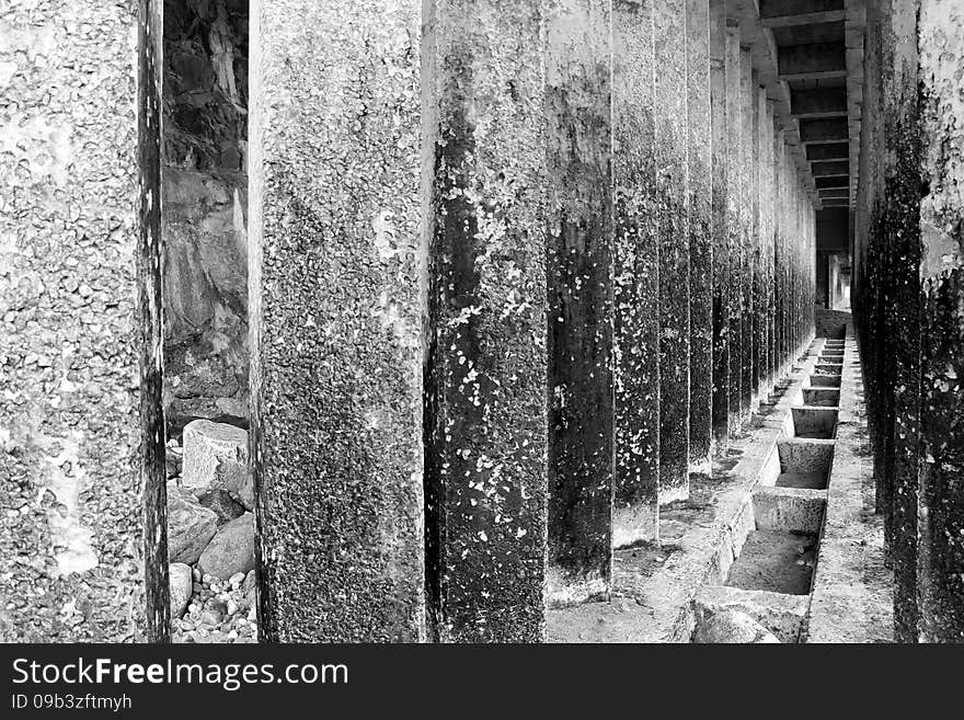 Corridor of concrete pillars with perspective depth black and white. Corridor of concrete pillars with perspective depth black and white