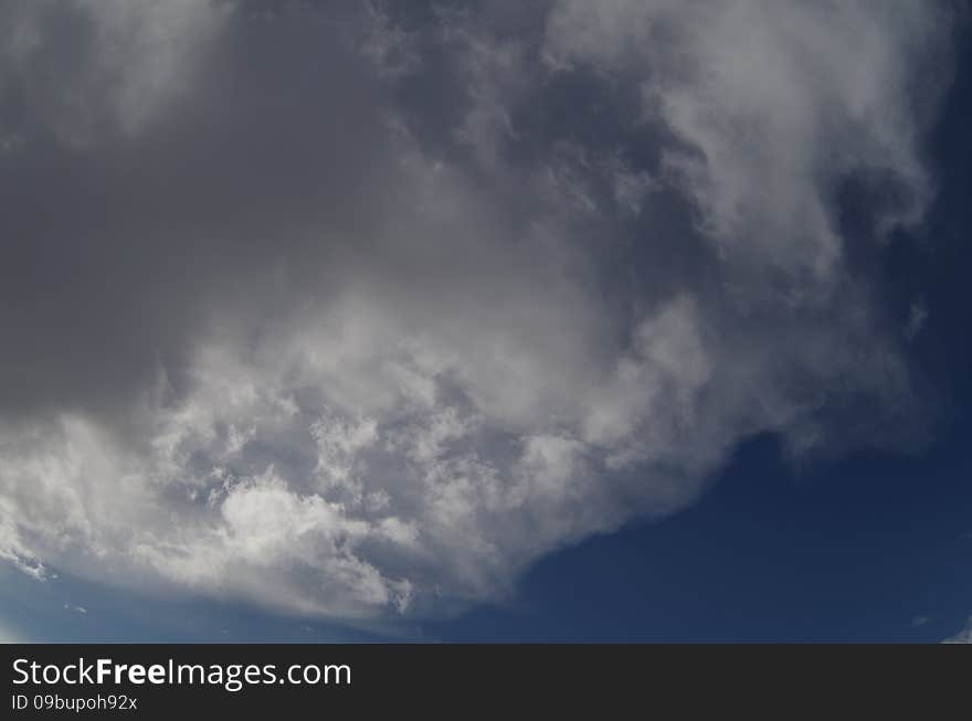 Grey clouds in the blue sky