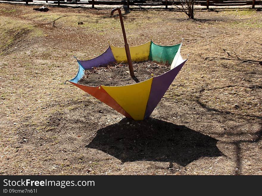 Flower Bed In The Form Of An Umbrella In The Early Spring.