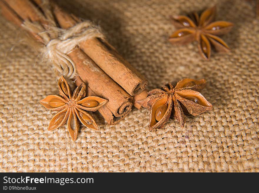 Few star anise and cinnamon sticks on old cloth