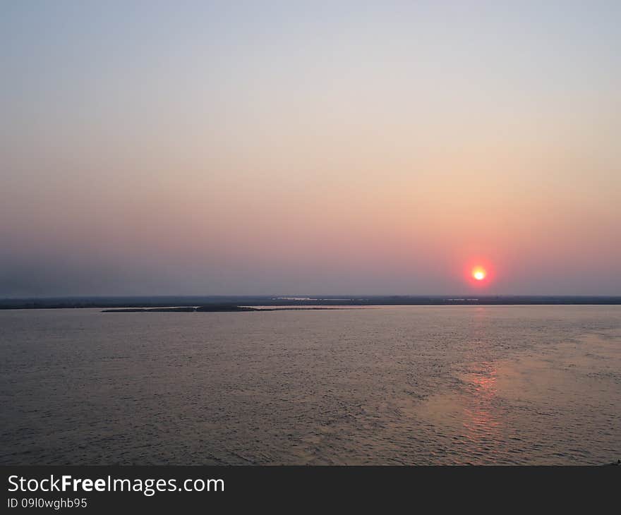 Sunset enveloped the river by the end of the passing day. Sunset enveloped the river by the end of the passing day.