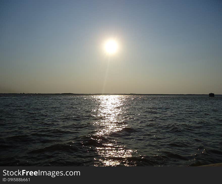 Sunset enveloped the river by the end of the passing day. Sunset enveloped the river by the end of the passing day.