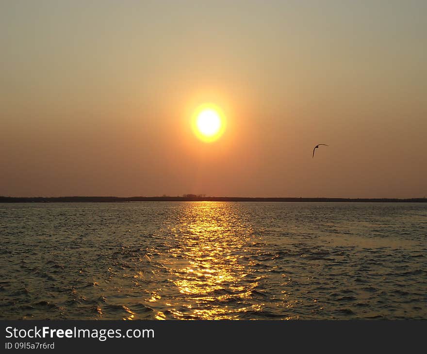 Sunset enveloped the river by the end of the passing day. Sunset enveloped the river by the end of the passing day.