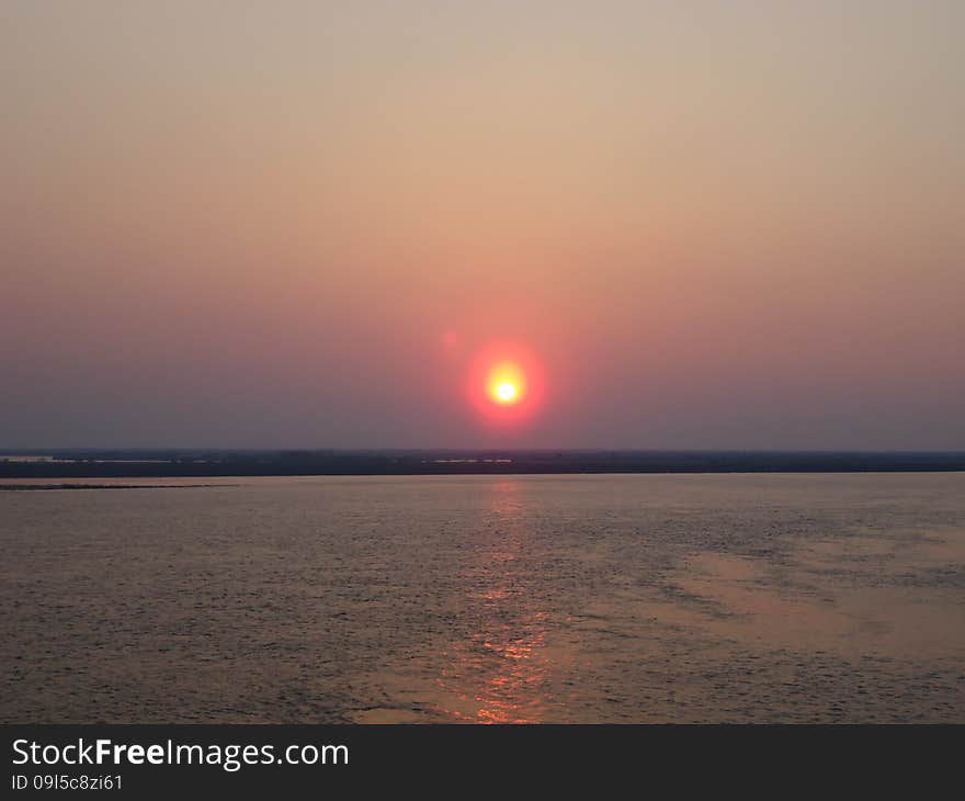 Sunset enveloped the river by the end of the passing day. Sunset enveloped the river by the end of the passing day.