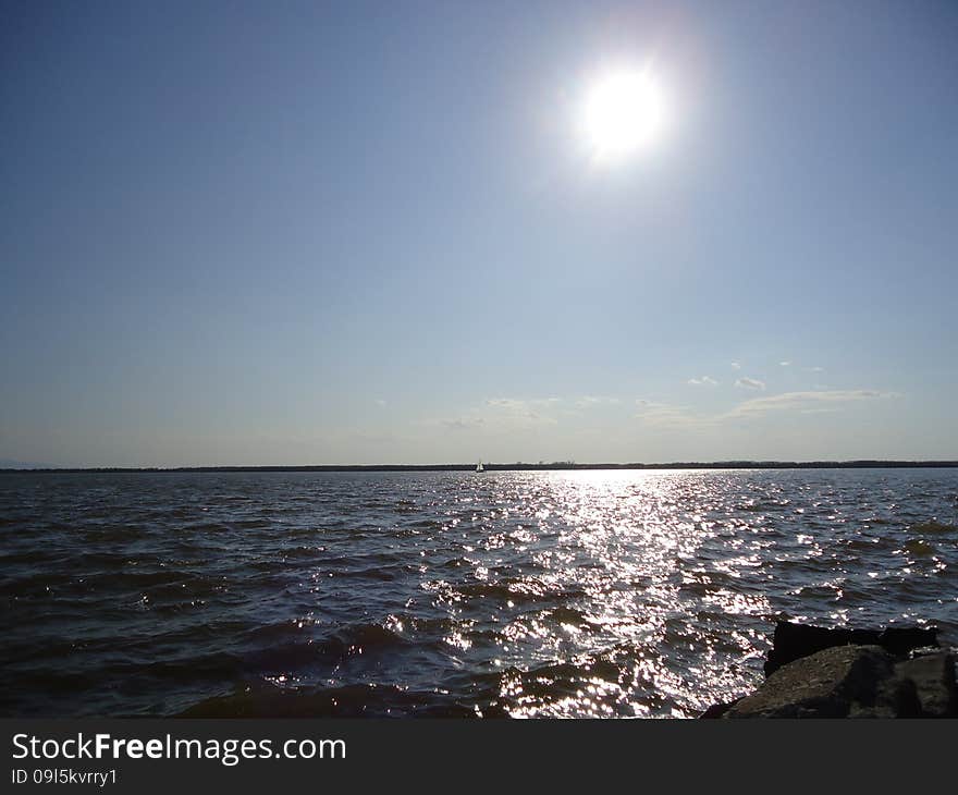 Sailboat floats alone on vast expanses of the river. Sailboat floats alone on vast expanses of the river.