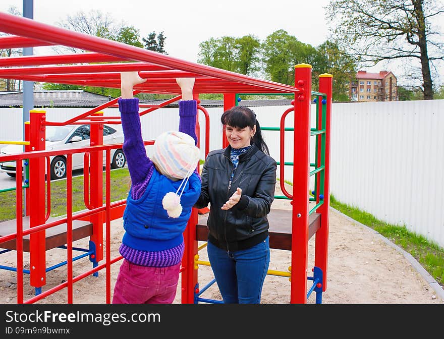 Mother playing with her daughter on the playground