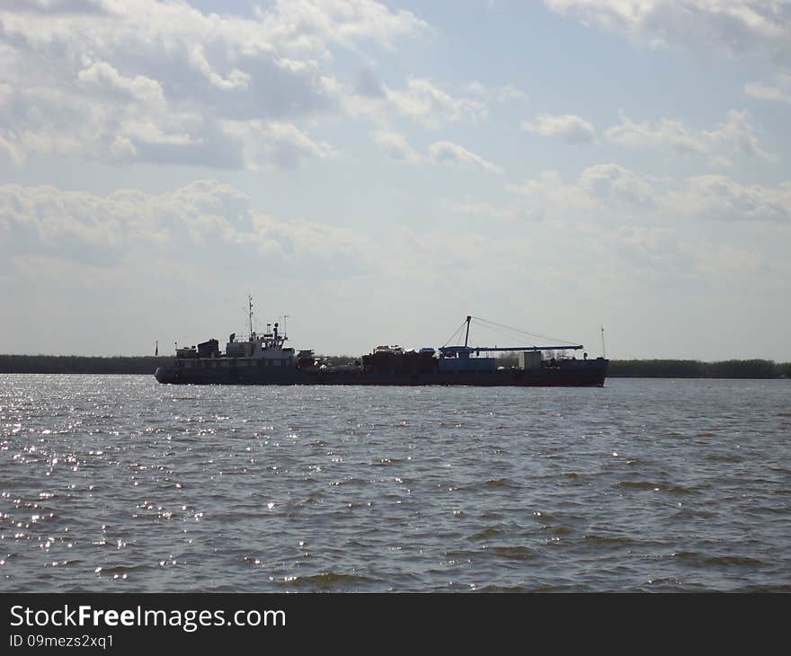 Riverboat on the vast expanse of the river. Riverboat on the vast expanse of the river.