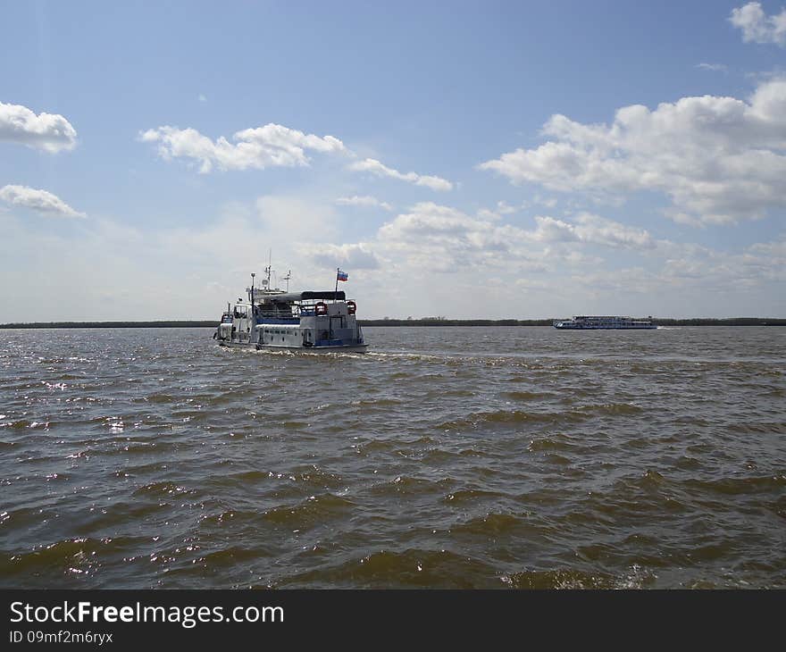 Riverboat on the vast expanse of the river. Riverboat on the vast expanse of the river.