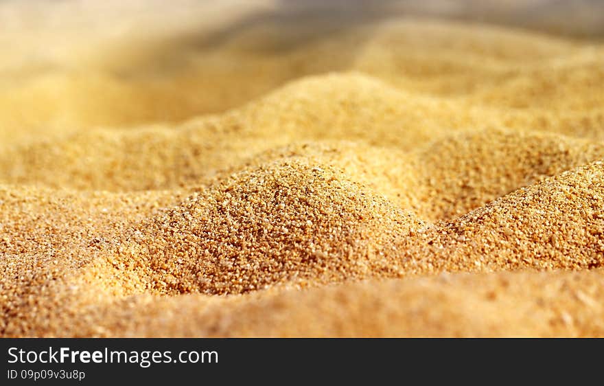 Texture of beach sand is photographed close-up