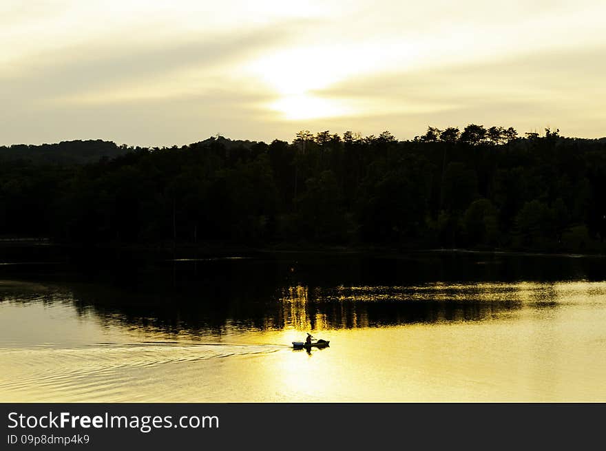 Kayaker On The Lake At Sunset