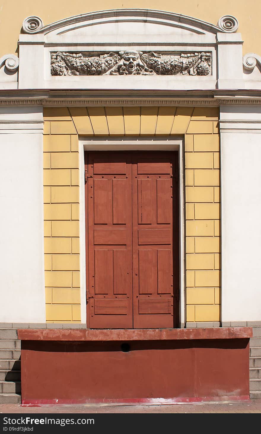 Retro front door decorated with bas-reliefs on sunny day, detail