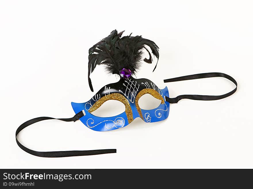 Festive blue Venetian Mask with Feather and Ribbon on White Background with Soft Shadow