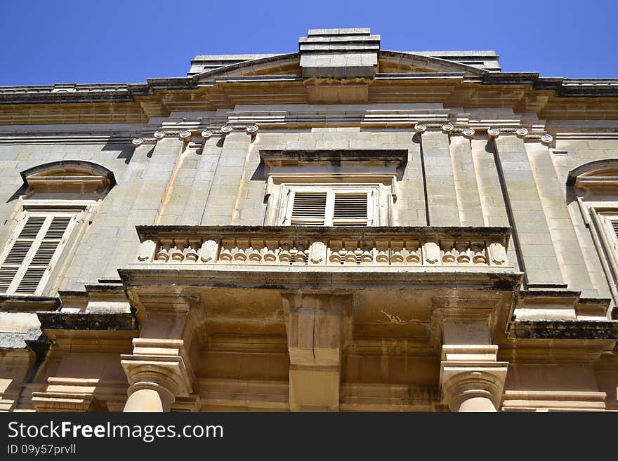 Ancient windows and balconies of a building in the classical style