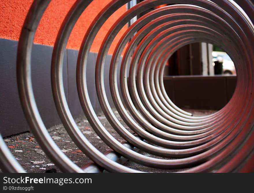 Fragment of large metal spiral as an abstract background outside closeup. Fragment of large metal spiral as an abstract background outside closeup