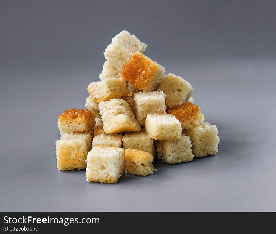 Pyramid Made Of Croutons Isolated On Grey