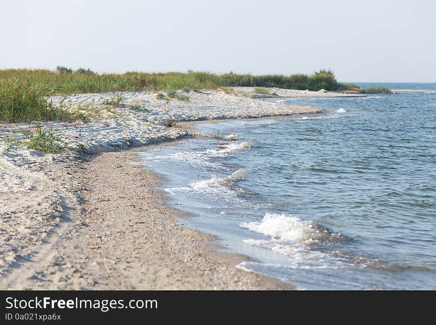 Sandy foreland at seaside at warm summer morning. Sandy foreland at seaside at warm summer morning