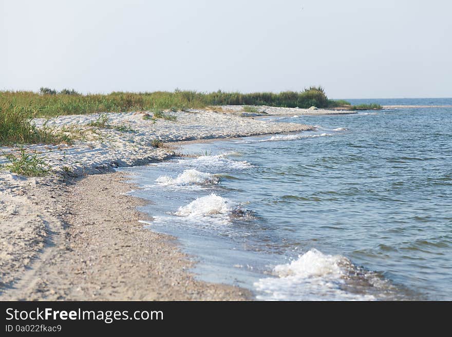 Sandy foreland at seaside at warm summer day. Sandy foreland at seaside at warm summer day