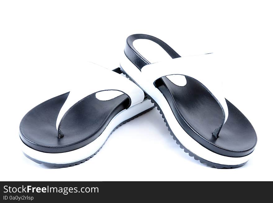 Leather flip flops photographed in studio on white background