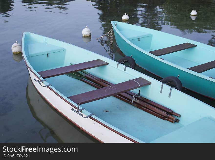 2 Blue Rowing Boats At Border Of Lake