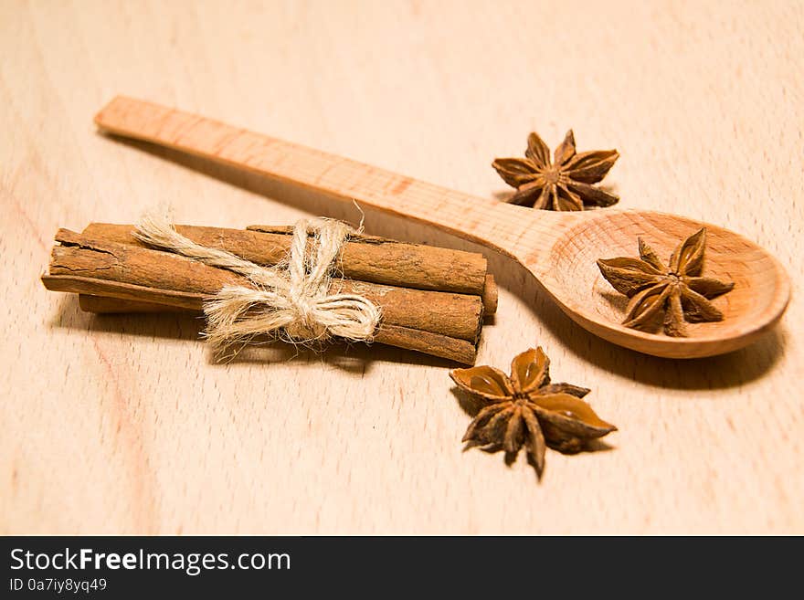 Spoon, Cinnamon And Star Anise On A Wooden Surface