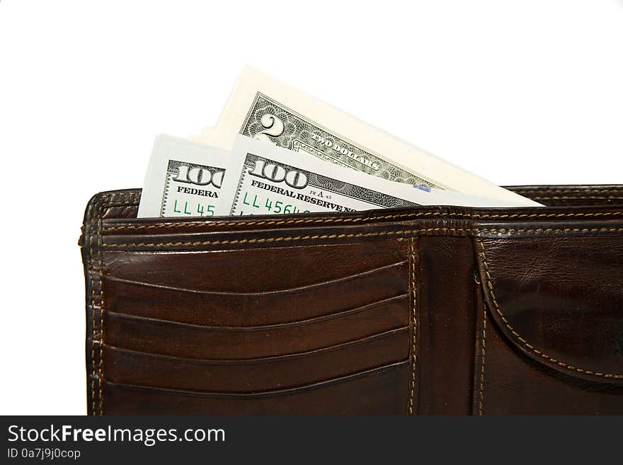 Old leather wallet with banknotes of US dollars inside