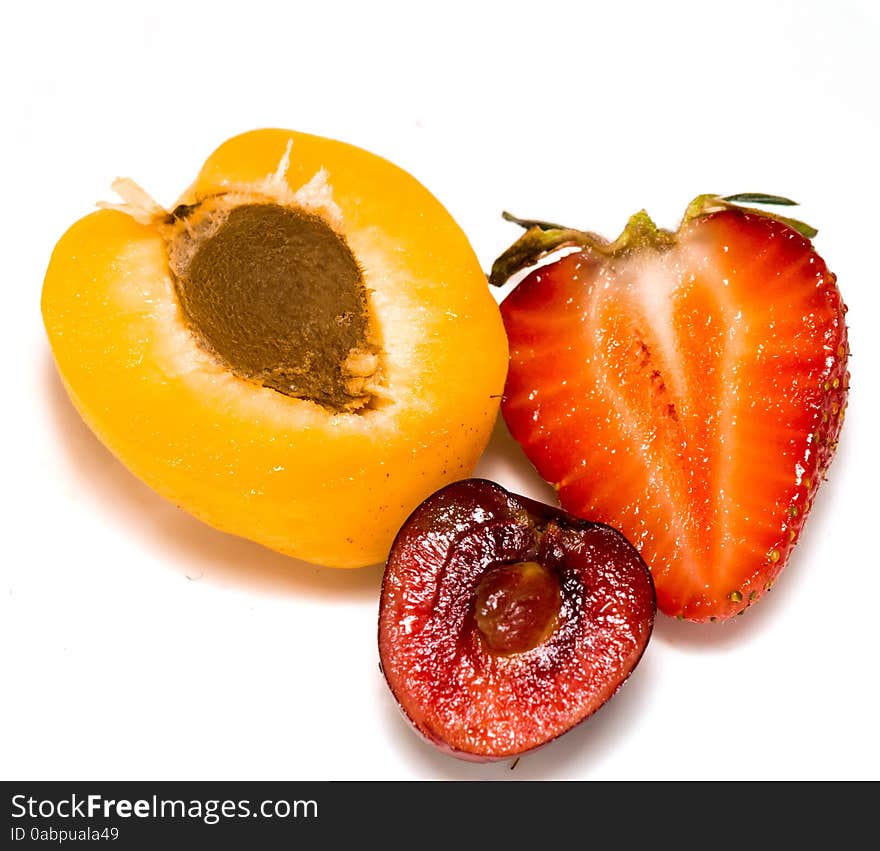 Fresh ripe apricot, cherry and strawberry close up background.