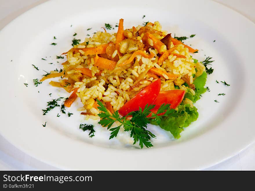 Fresh tasty salad of rice and vegetables on a plate closeup