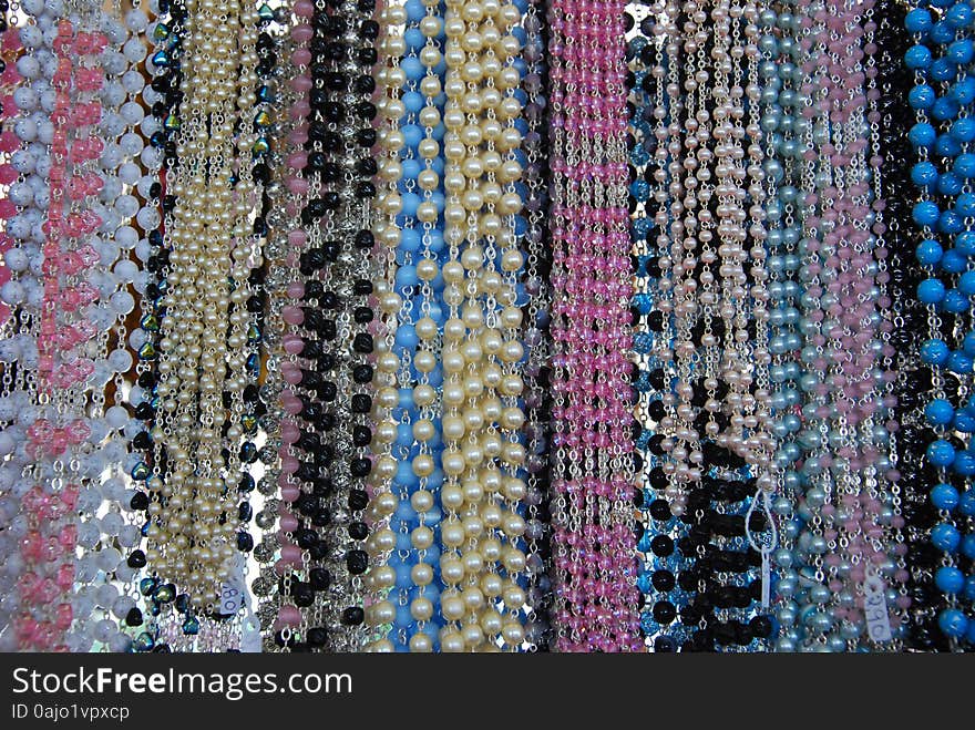 Many Pearl Necklaces Hanging in front of Mirror. Many Pearl Necklaces Hanging in front of Mirror